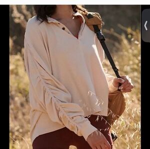 Free People Movement flow state layering top in an orange/coral color.